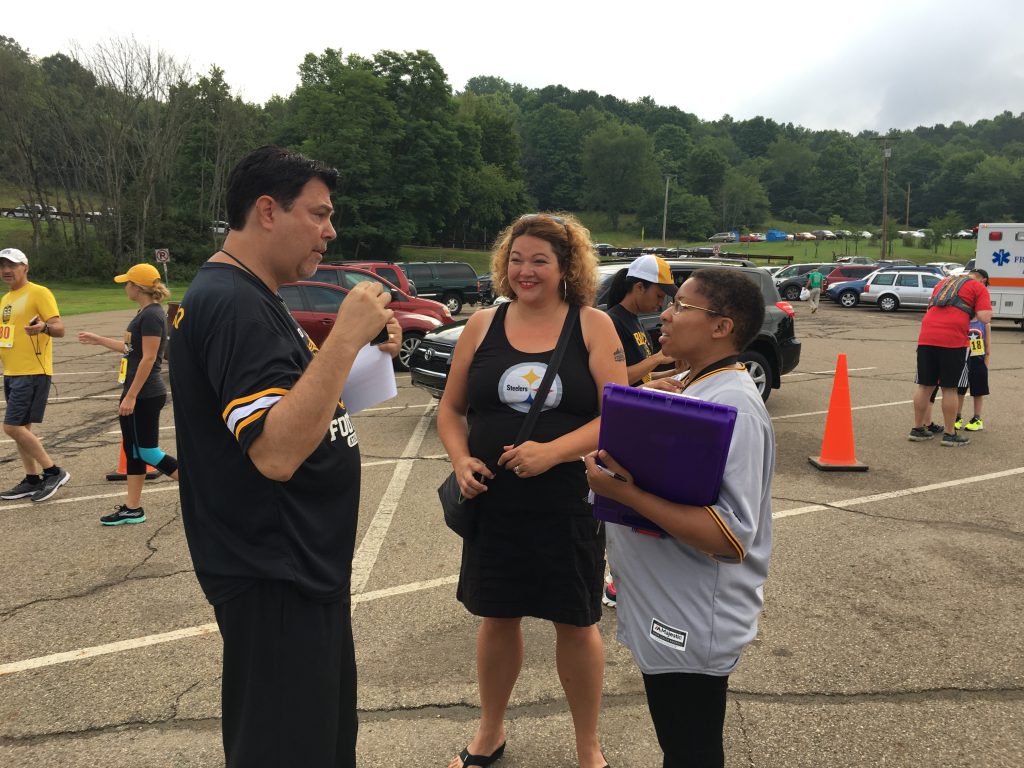 Jimmy Krenn talking with Jessi Marsh and Maggie Johnson from the Light of Life Rescue Mission, which organized the Yinzer 5K.